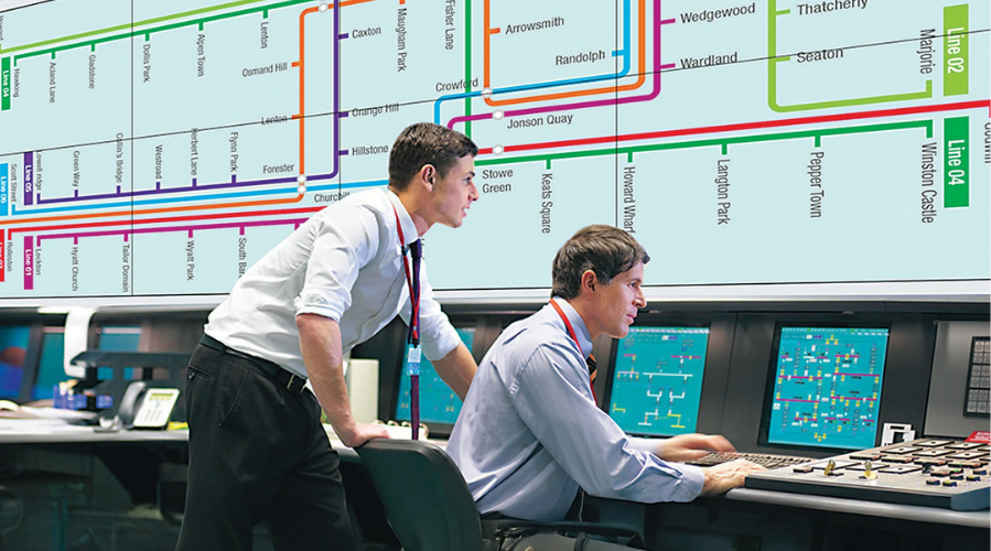 staff reviewing mapping on large format display in a control room